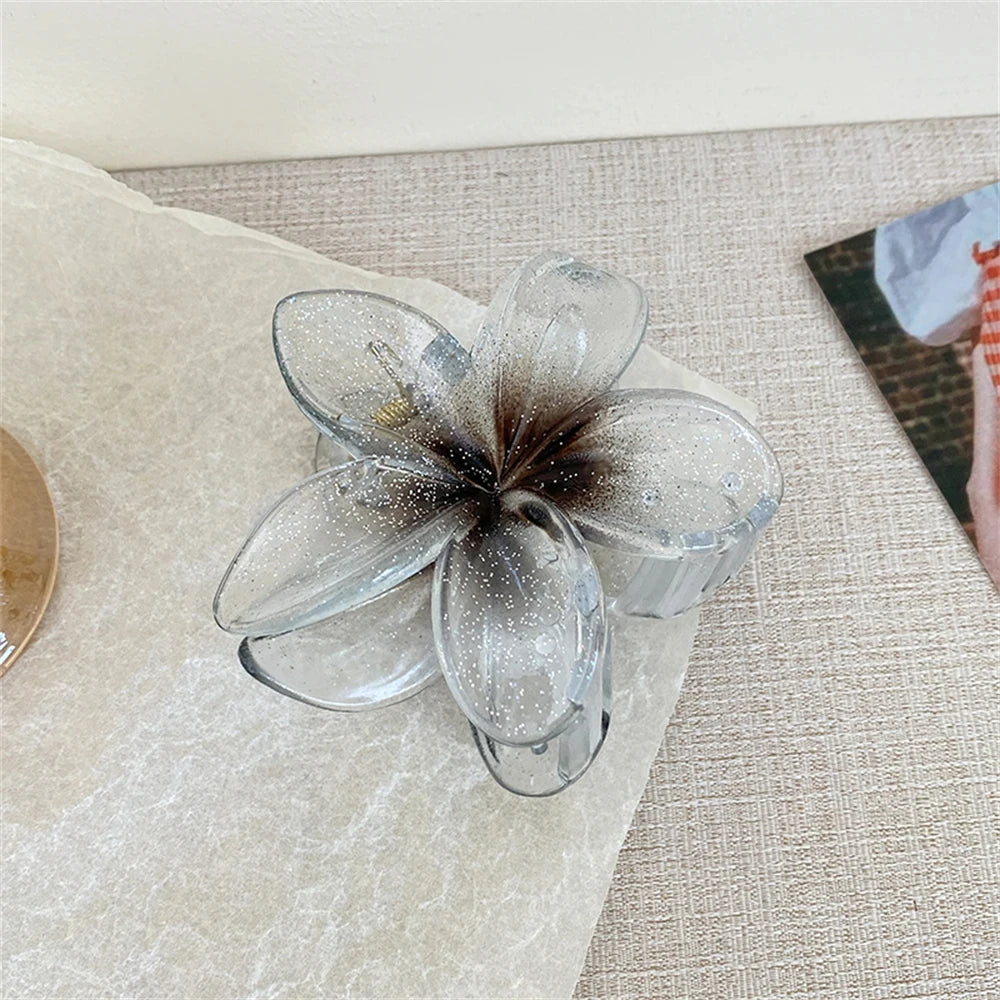 Glitzernde Haarkralle mit Blumenmotiv