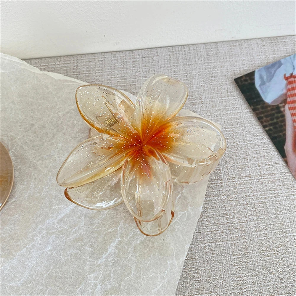 Glitzernde Haarkralle mit Blumenmotiv