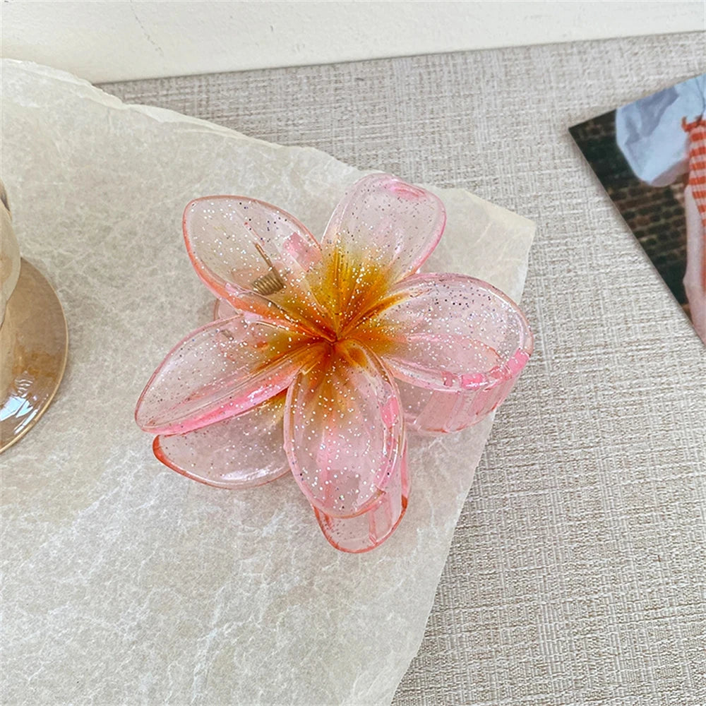 Glitzernde Haarkralle mit Blumenmotiv
